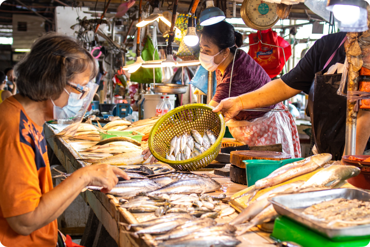 Busy stalls at Dam Market selling local produce and souvenirs